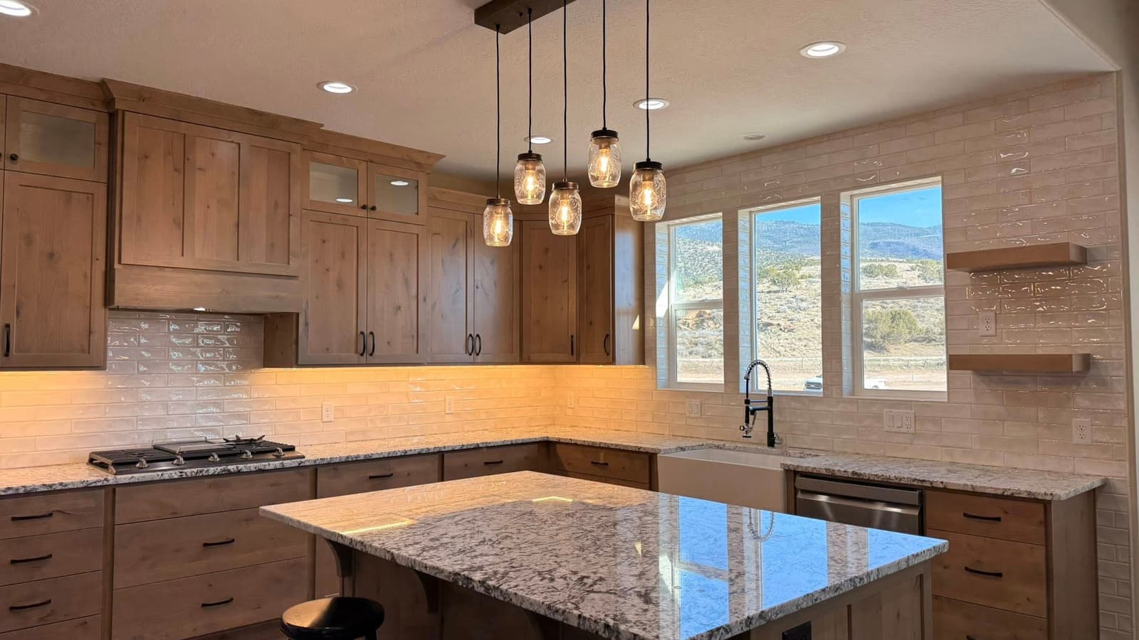 Custom kitchen with warm wood cabinets and a granite island