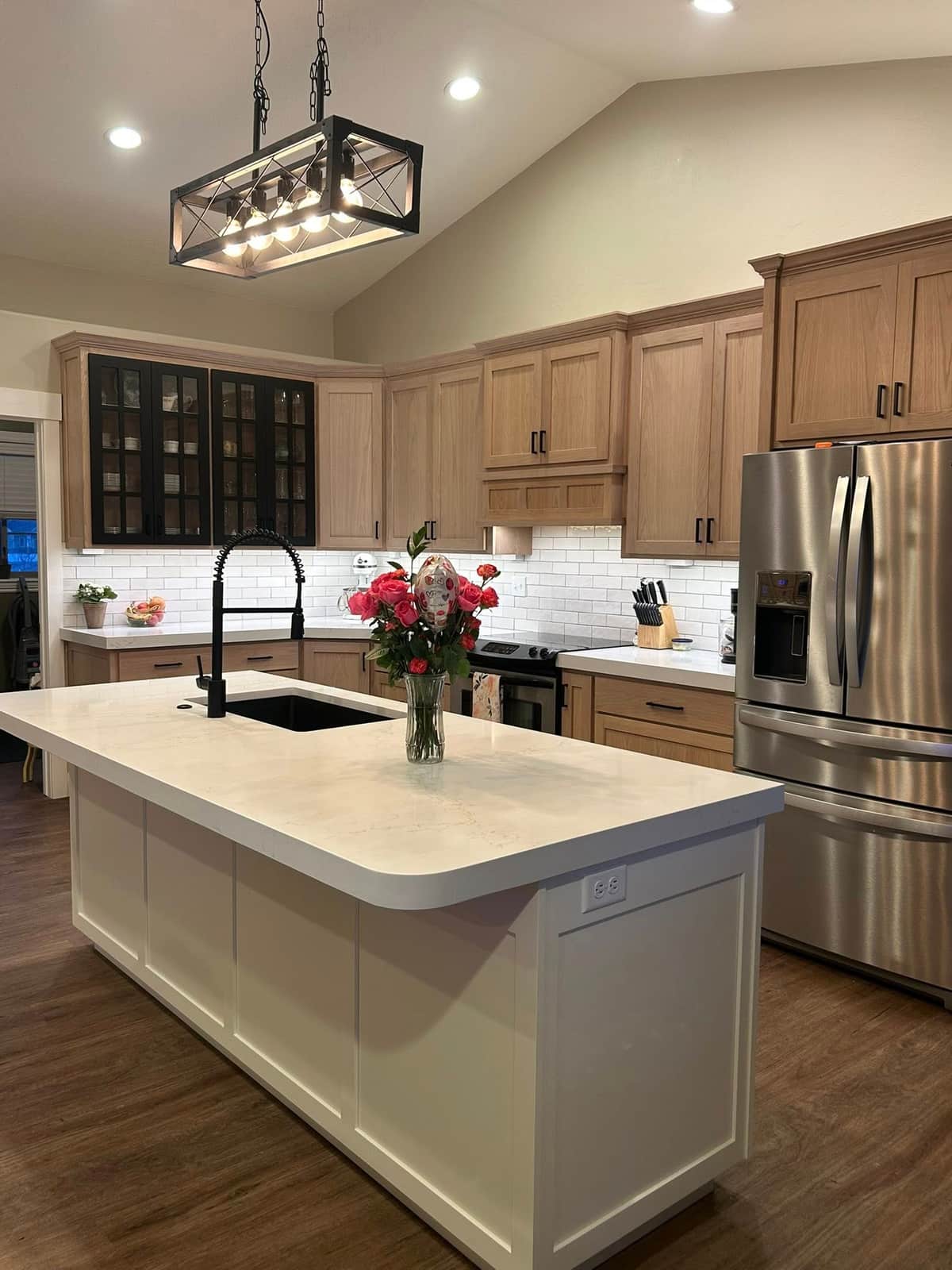 Kitchen island with linear pendant and fresh flowers
