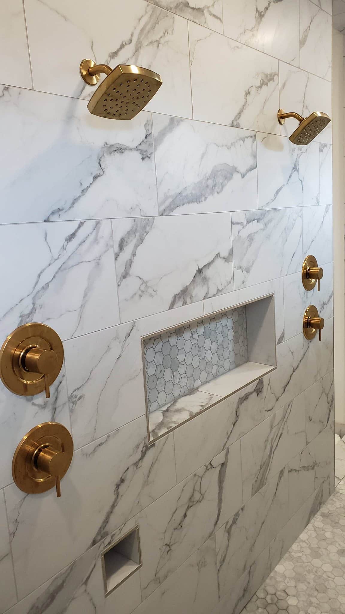 Marble shower with brushed-gold fixtures