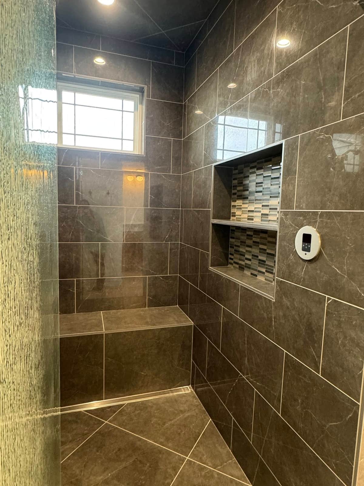 Slate-tiled walk-in shower with a built-in bench